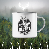 Emaille-Tasse Nix Geschossen vor nebligem Waldfoto, mit weissem Hirschgeweih-Symbol und Dekorlinien darunter